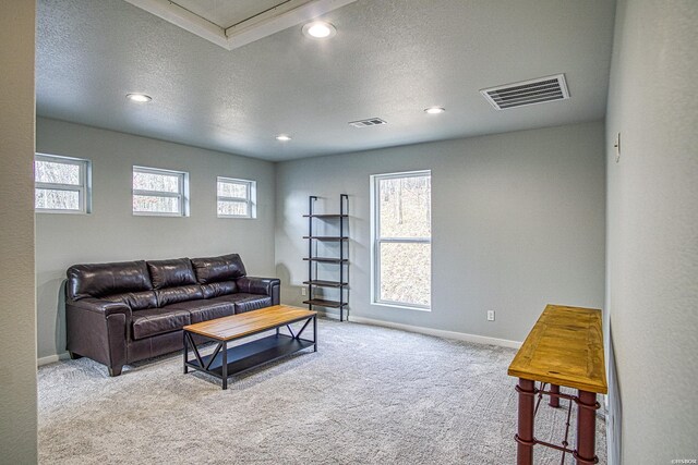 living room with recessed lighting, visible vents, carpet flooring, a textured ceiling, and baseboards