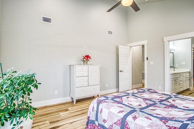 bedroom featuring light wood finished floors, baseboards, and visible vents