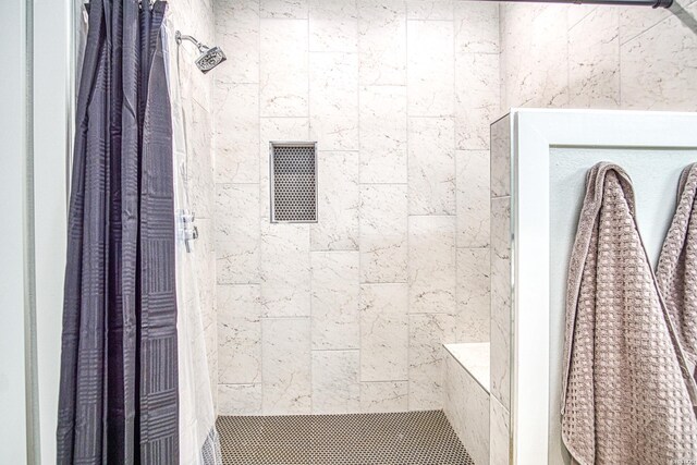 full bath featuring a tile shower