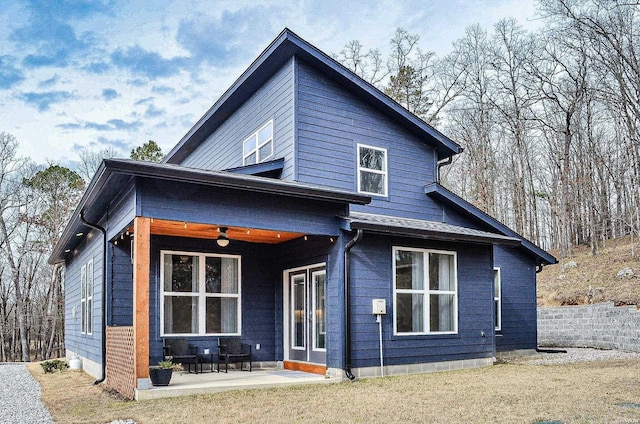 rear view of property featuring a patio area