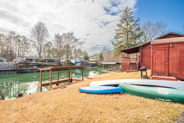 exterior space with a water view, a boat dock, and stairs