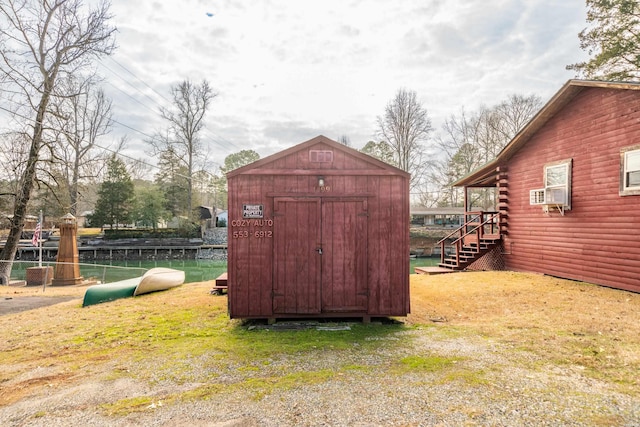 view of shed featuring fence