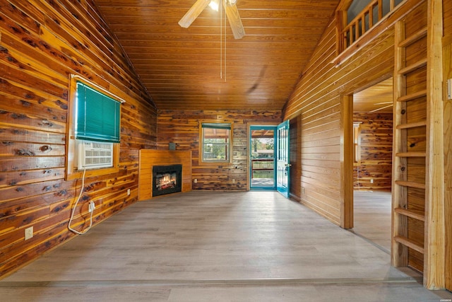 unfurnished living room with a warm lit fireplace, wooden ceiling, and vaulted ceiling