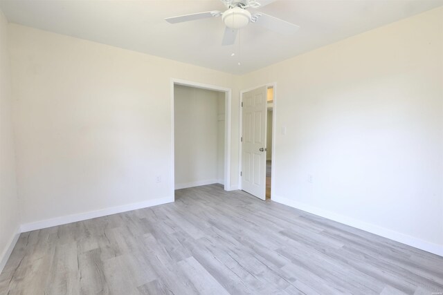 unfurnished room with ceiling fan, light wood-type flooring, and baseboards