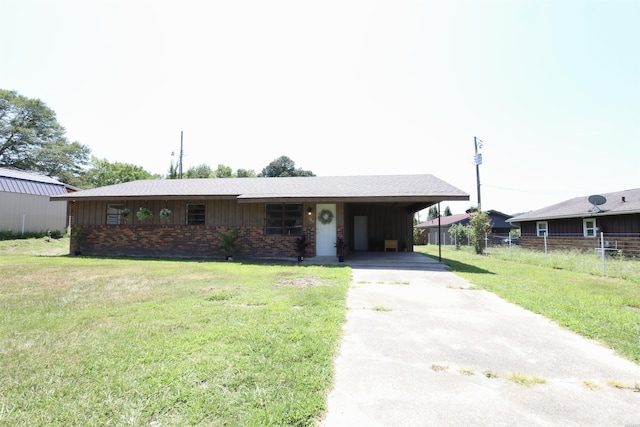 single story home featuring driveway, a front lawn, a carport, and brick siding