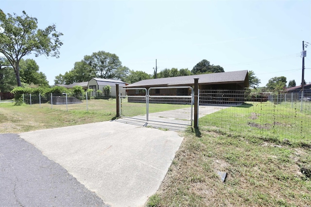 view of car parking with concrete driveway and fence