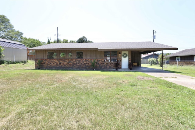 single story home featuring a front yard, an attached carport, concrete driveway, and brick siding