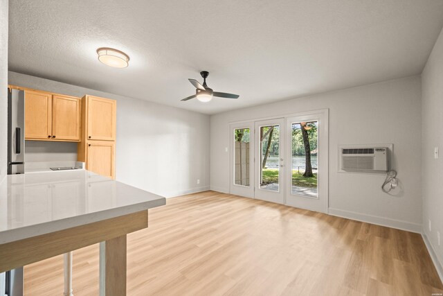 183 River Mill Ct Unit B-2, Hot Springs, AR 71913 - unfurnished living room featuring ceiling fan, light wood finished floors, and a wall mounted air conditioner