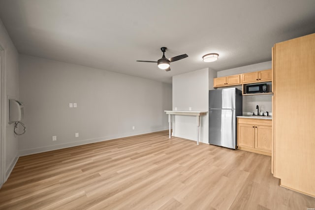 183 River Mill Ct Unit B-2, Hot Springs, AR 71913 - kitchen with freestanding refrigerator, light brown cabinetry, light wood-style flooring, a ceiling fan, and light countertops
