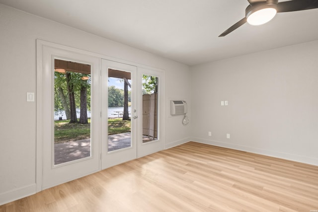 183 River Mill Ct Unit B-2, Hot Springs, AR 71913 - spare room featuring french doors, light wood-type flooring, ceiling fan, and an AC wall unit