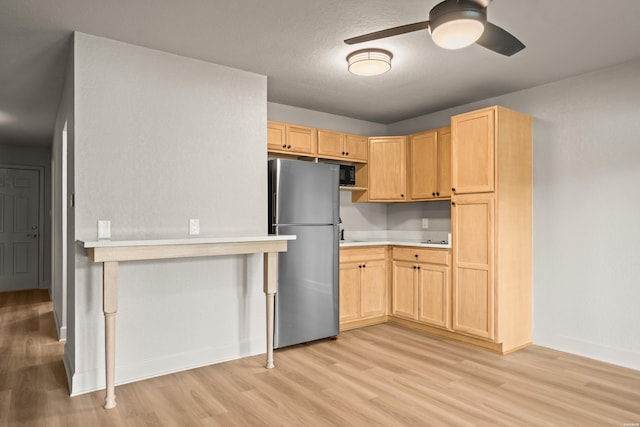 183 River Mill Ct Unit B-2, Hot Springs, AR 71913 - kitchen featuring freestanding refrigerator, light wood finished floors, light brown cabinets, a ceiling fan, and light countertops