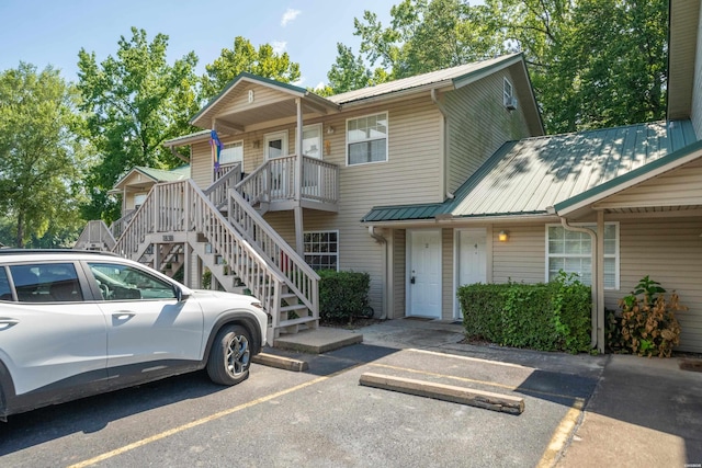 183 River Mill Ct Unit B-2, Hot Springs, AR 71913 - view of front facade featuring a metal roof, stairway, uncovered parking, and covered porch