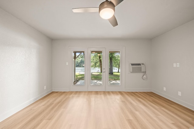 183 River Mill Ct Unit B-2, Hot Springs, AR 71913 - spare room featuring light wood-style flooring, a ceiling fan, and a wall mounted air conditioner