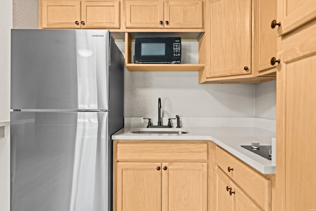 183 River Mill Ct Unit B-2, Hot Springs, AR 71913 - kitchen featuring freestanding refrigerator, light brown cabinets, black microwave, and light countertops