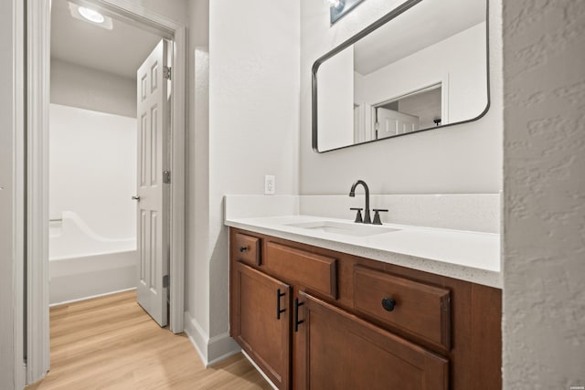 183 River Mill Ct Unit B-2, Hot Springs, AR 71913 - bathroom featuring vanity, wood finished floors, and a tub to relax in