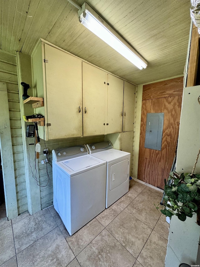 clothes washing area featuring cabinet space, electric panel, wood ceiling, separate washer and dryer, and light tile patterned flooring