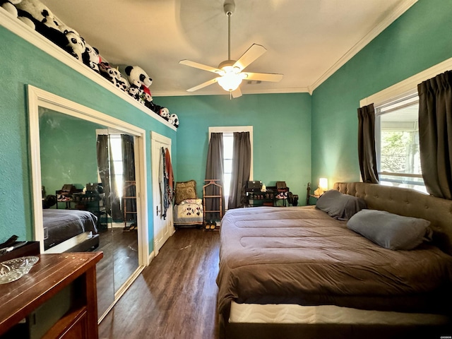 bedroom with ornamental molding, ceiling fan, and dark wood-style floors