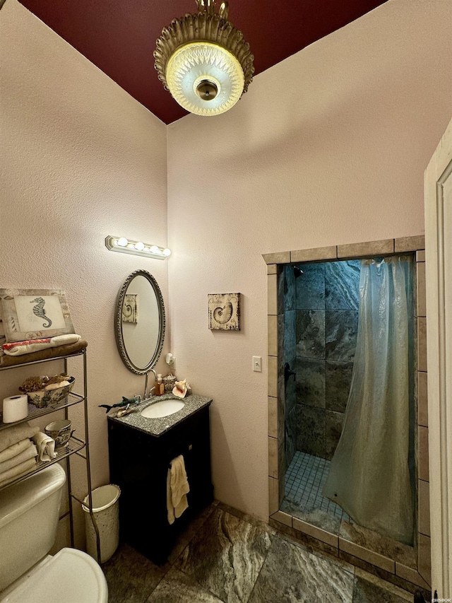 full bath with toilet, a shower stall, and vanity