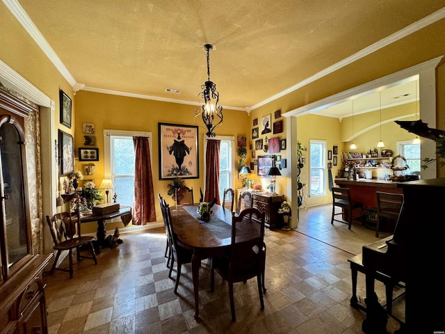 dining room featuring ornamental molding, plenty of natural light, visible vents, and baseboards