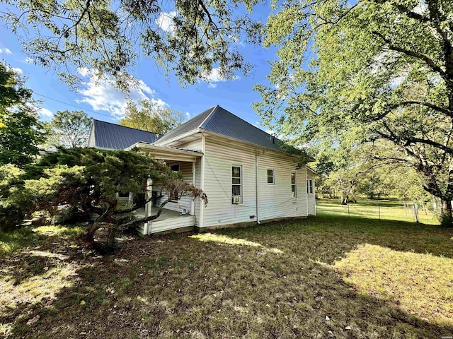 view of home's exterior with a yard and fence