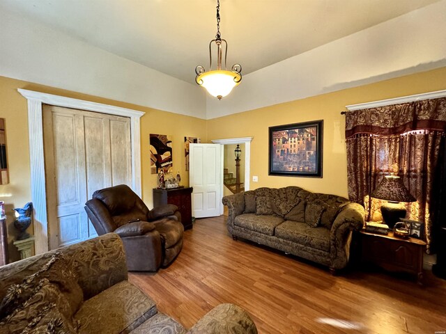 living room featuring vaulted ceiling and wood finished floors