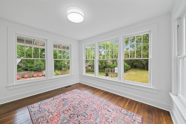 unfurnished sunroom with visible vents and a healthy amount of sunlight