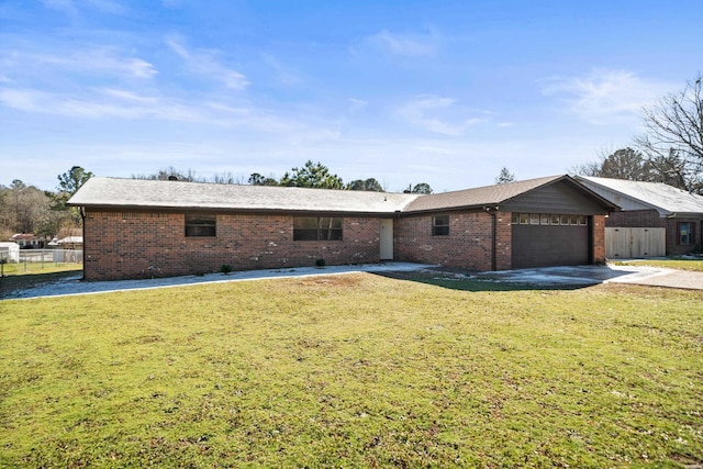 ranch-style home with driveway, a front lawn, an attached garage, and brick siding