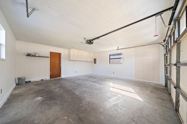 garage featuring baseboards and a garage door opener