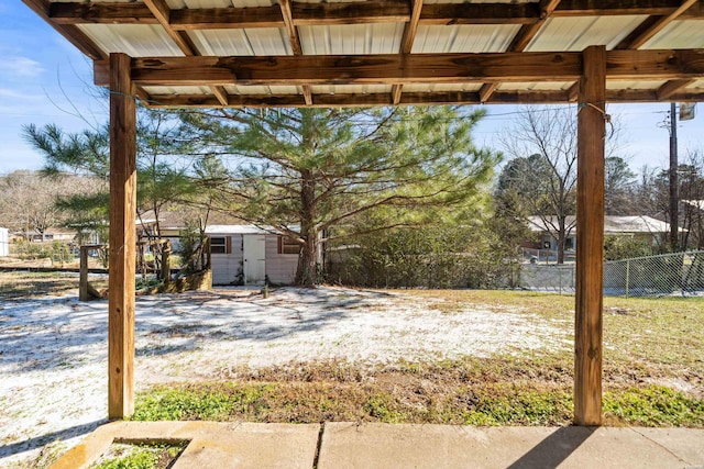 view of yard with an outdoor structure, a storage shed, and fence