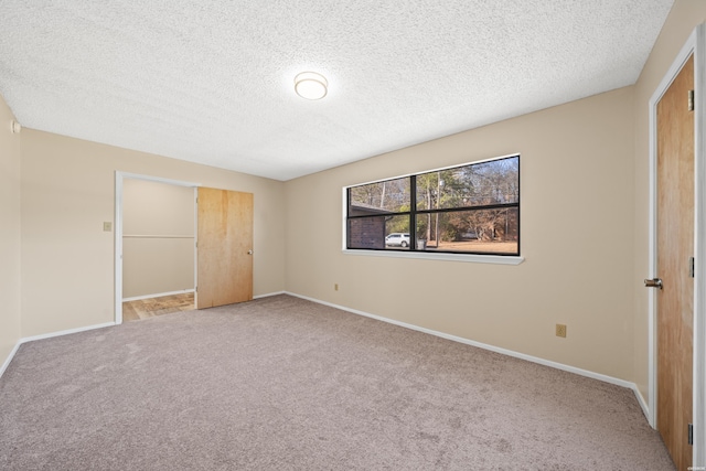 unfurnished bedroom featuring a closet, carpet flooring, and baseboards