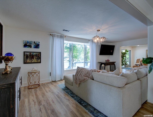370 Restful Ridge Rd, Hot Springs, AR 71913 - living area with healthy amount of natural light, light wood finished floors, baseboards, and a textured ceiling