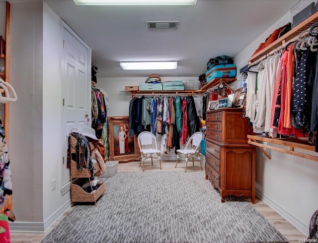 spacious closet with light wood-style flooring and visible vents