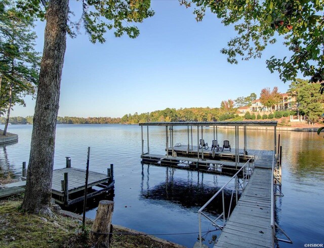 view of dock featuring a water view and boat lift