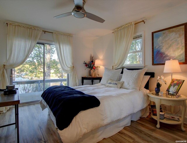 bedroom featuring wood finished floors, a ceiling fan, and access to exterior