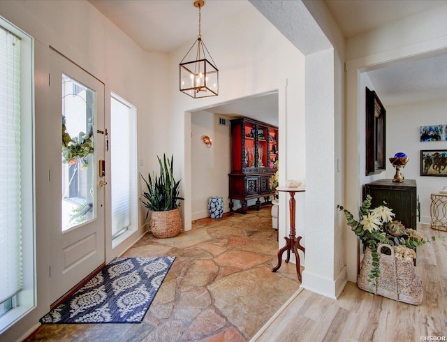 370 Restful Ridge Rd, Hot Springs, AR 71913 - entryway featuring a chandelier, light wood-style floors, and baseboards