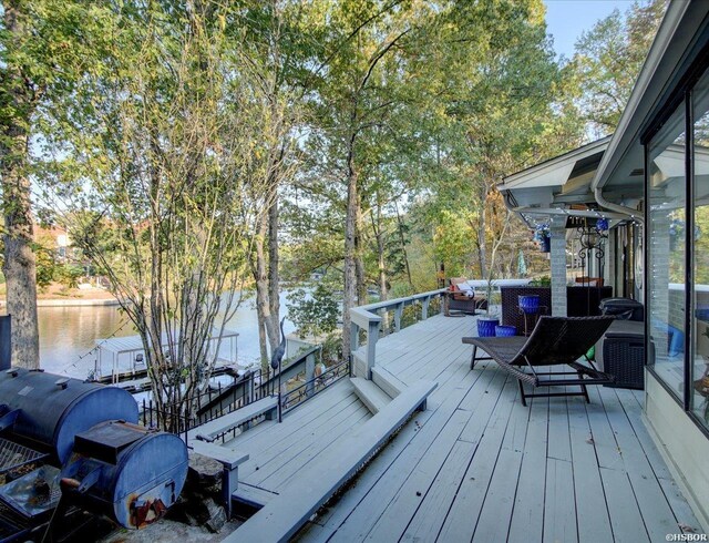 wooden deck featuring a water view