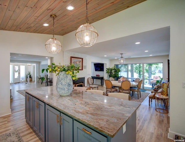 370 Restful Ridge Rd, Hot Springs, AR 71913 - kitchen featuring open floor plan, healthy amount of natural light, light stone countertops, decorative light fixtures, and recessed lighting