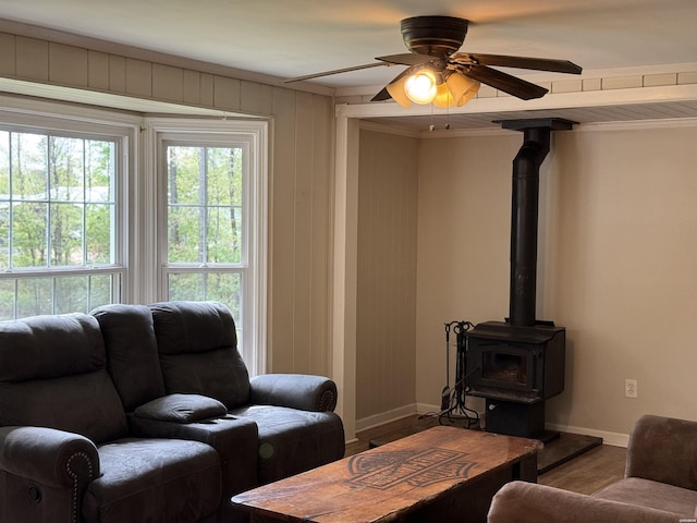 5301 Owensville Cutoff Cutoff, Lonsdale, AR 72087 - living area featuring a wood stove, baseboards, ceiling fan, and wood finished floors