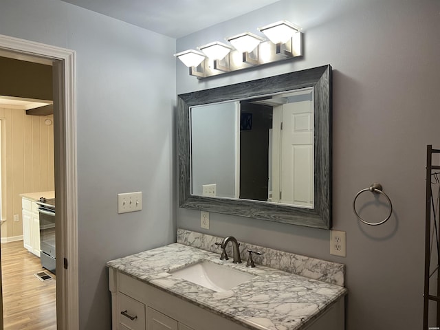 5301 Owensville Cutoff Cutoff, Lonsdale, AR 72087 - bathroom featuring wood finished floors, vanity, and visible vents
