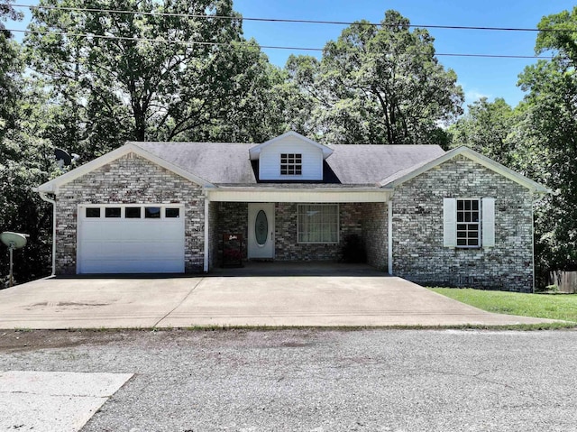 single story home with concrete driveway, brick siding, and a garage