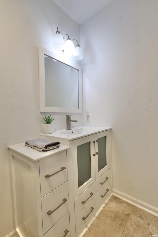 bathroom with baseboards and vanity