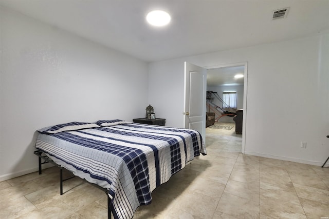 bedroom featuring baseboards and visible vents