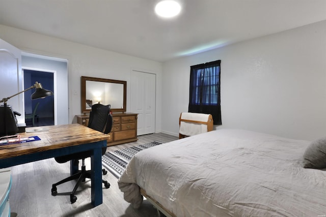 bedroom with baseboards and light wood-style flooring