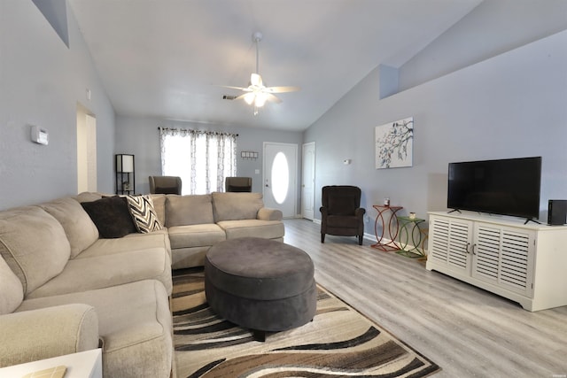 living room with visible vents, baseboards, ceiling fan, light wood-type flooring, and high vaulted ceiling