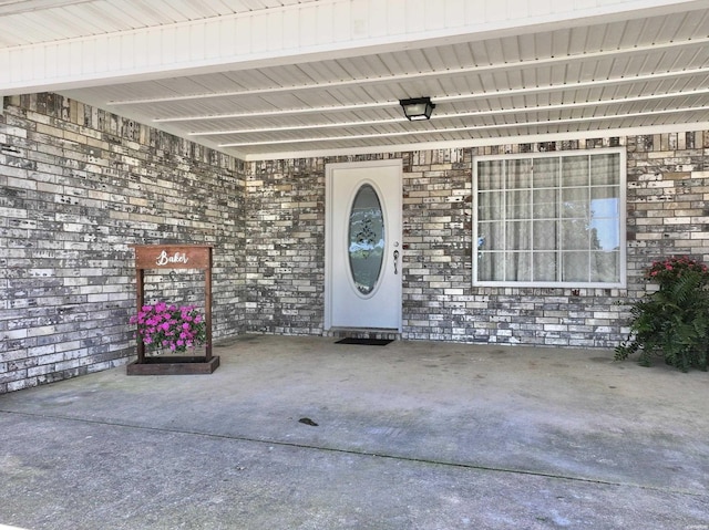 entrance to property with brick siding