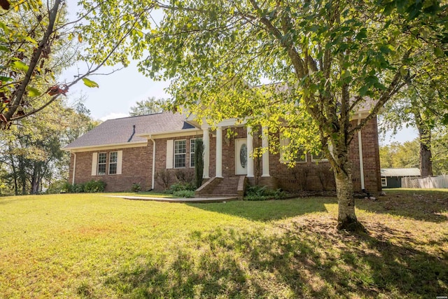 view of front of house with a front yard and brick siding