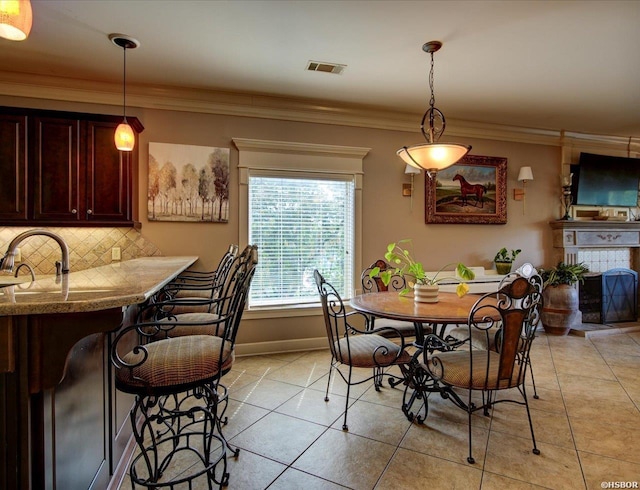 503 Lakeland Dr Unit E6, Hot Springs, AR 71913 - dining space with a fireplace with raised hearth, visible vents, ornamental molding, light tile patterned floors, and baseboards