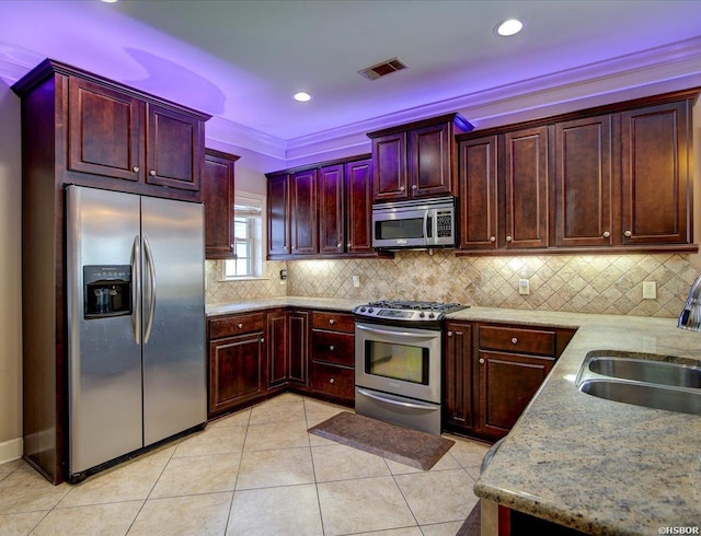 503 Lakeland Dr Unit E6, Hot Springs, AR 71913 - kitchen with stainless steel appliances, a sink, visible vents, backsplash, and reddish brown cabinets