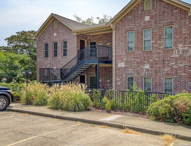 503 Lakeland Dr Unit E6, Hot Springs, AR 71913 - view of front of house featuring brick siding, stairs, uncovered parking, and fence