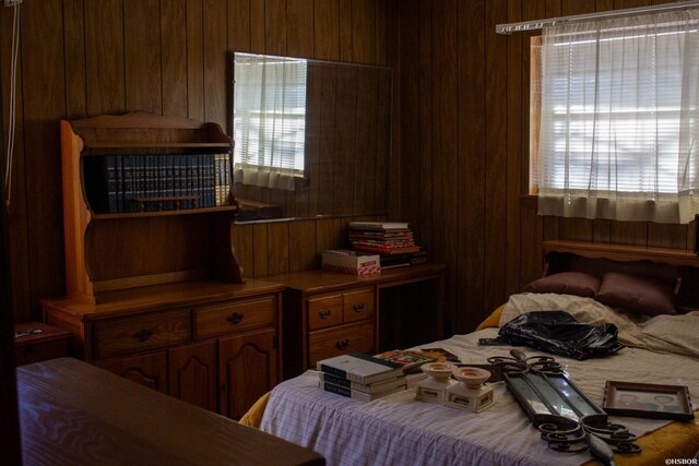 bedroom with wooden walls